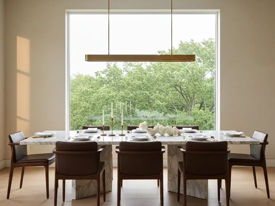 Custom Calacatta marble slab dining table with mitered slab base in a luxury dining room