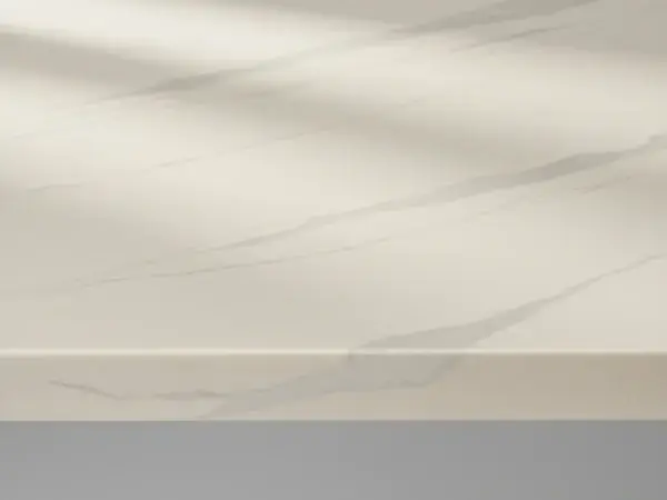 Polished engineered quartz countertop slab in warm white with soft grey veining